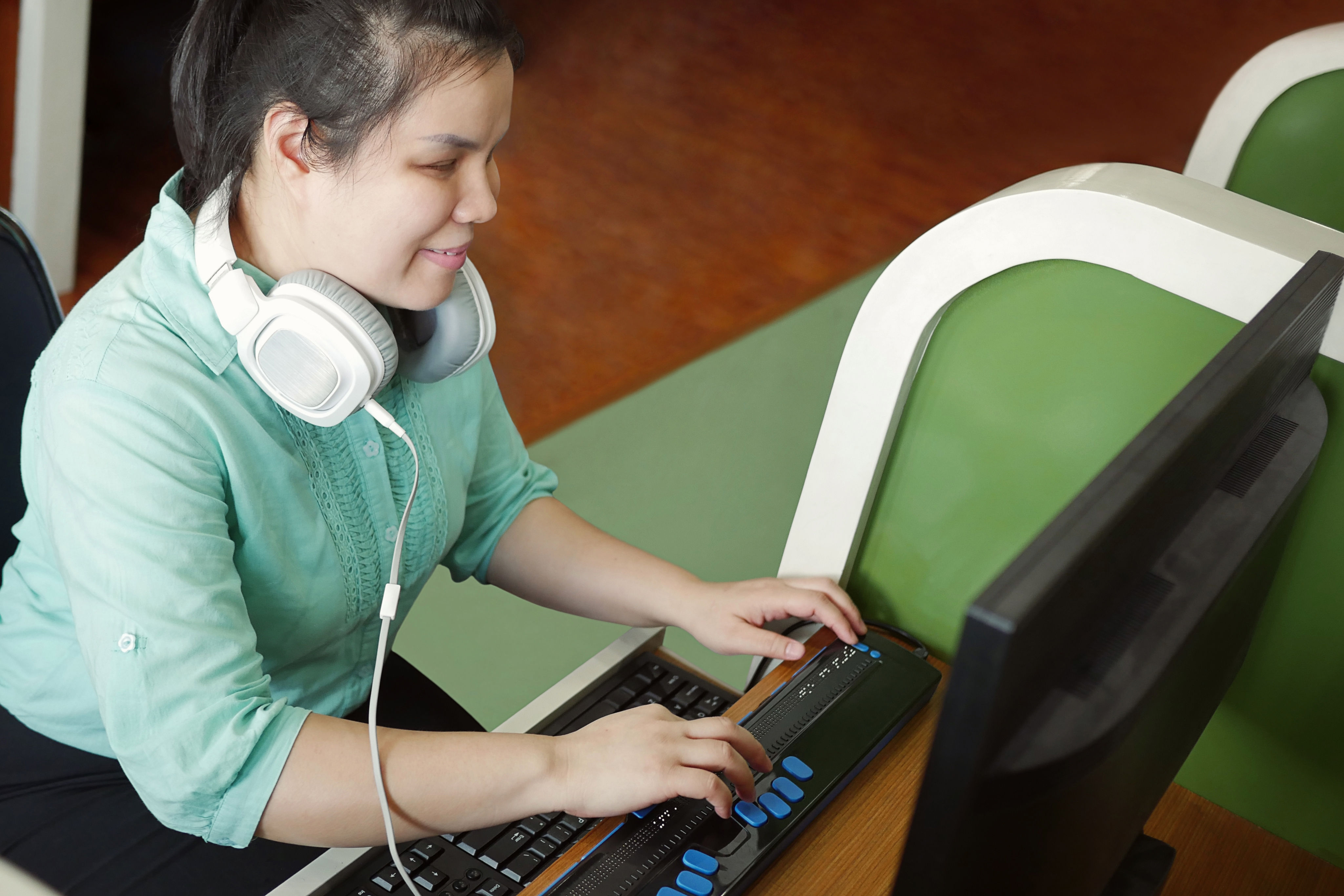 Visually Impaired Woman using desktop computer and keyboard