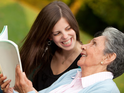 Grandmother and twenty-something granddaughter with book